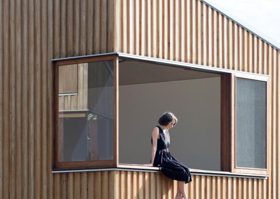 a woman sitting on a window ledge