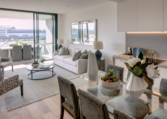 a living room with a glass table and chairs