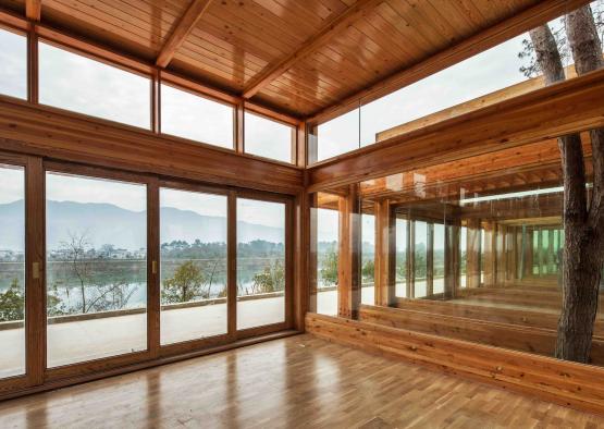 a room with glass walls and wood floors