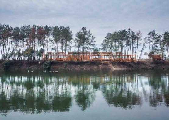 a body of water with trees and a structure