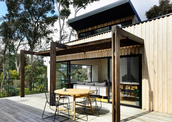 a patio with a table and chairs on a deck