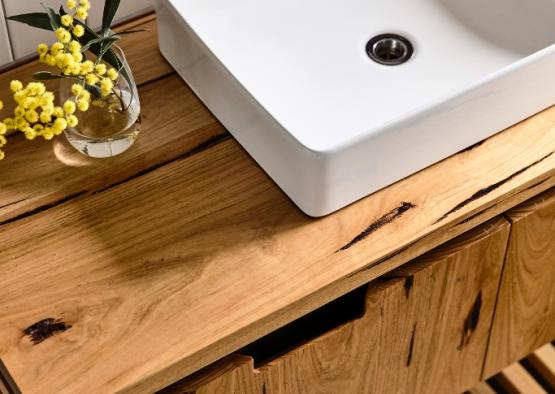 a white sink on a wooden counter