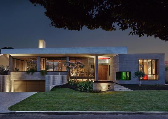 a house with a lawn and a large driveway