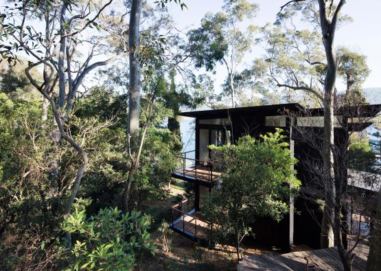 a building with a deck and trees