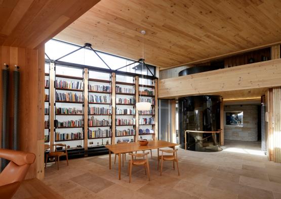 a room with a table and chairs and bookshelves