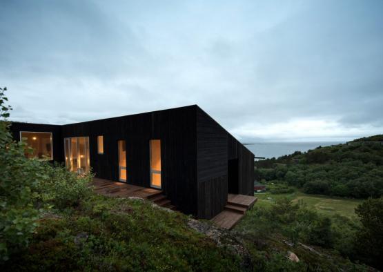 a house with a deck and a view of the ocean