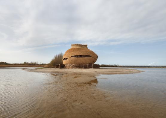 a round structure in the middle of a body of water