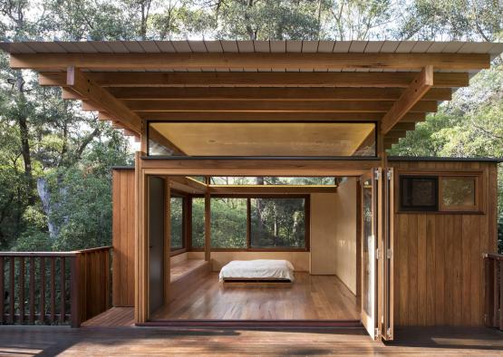 a wooden house with a bed