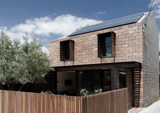 a house with a fence and a tree