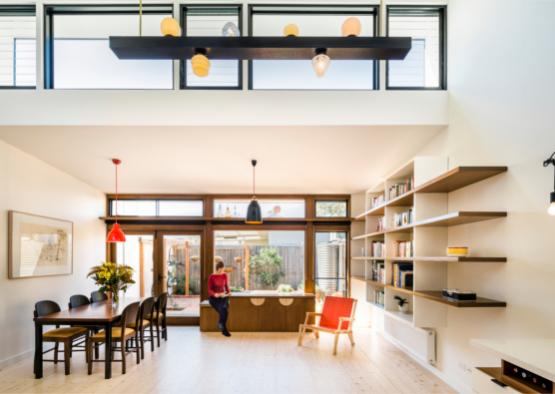 a room with a table and chairs and a window