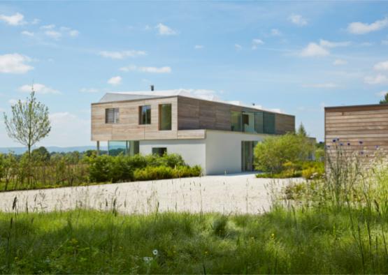 a house with a gravel driveway and bushes