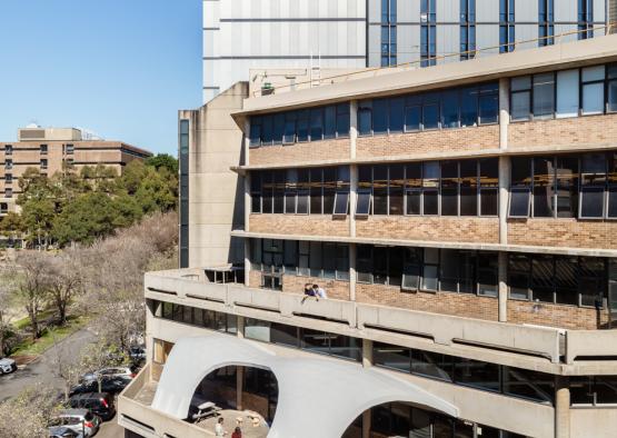 a building with a parking lot and trees