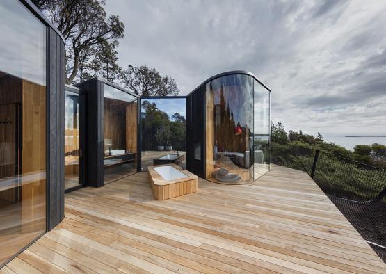 a wooden deck with a tub and a tub on it