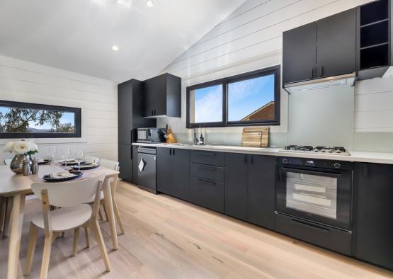 a kitchen with black cabinets and a table