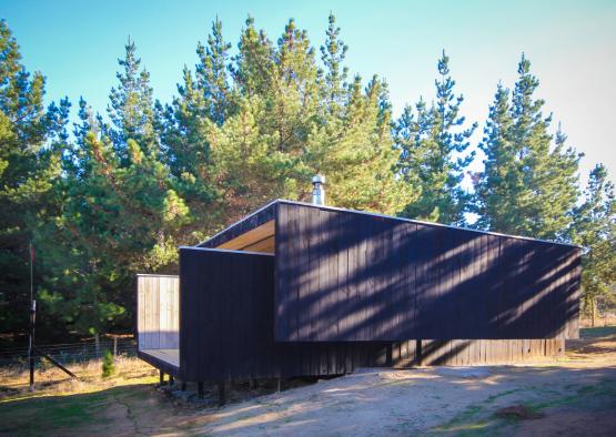 a building with a porch and a wood wall