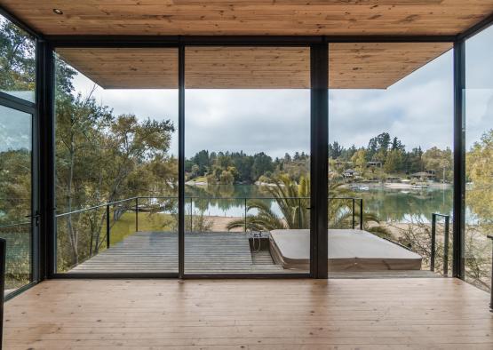 a deck with glass doors overlooking a lake