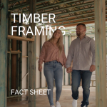 Man and woman walking through house being built with timber