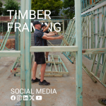 Two men on worksite lifting up treated timber frame