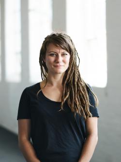 a woman with dreadlocks smiling