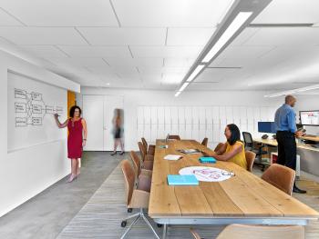 a woman standing in front of a whiteboard