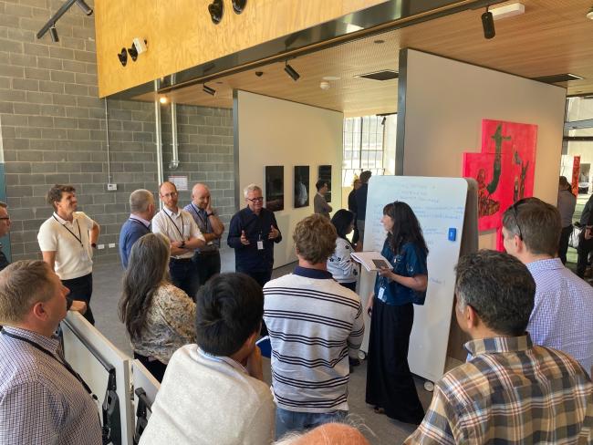 Group of people brainstorming around a whiteboard