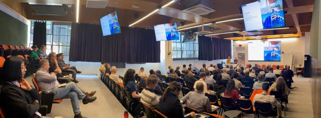 small auditorium of people watching presentations