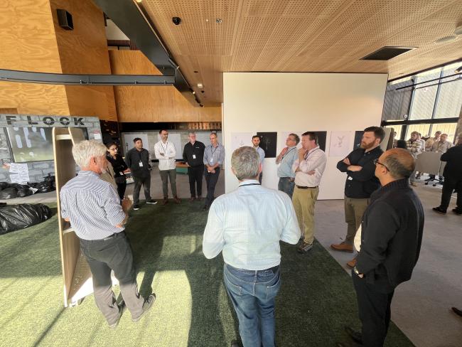 Group of people brainstorming around a whiteboard