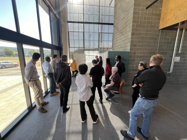 Group of people brainstorming around a whiteboard