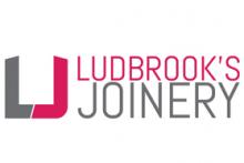 a logo with pink and grey letters