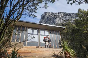 a couple of people standing on a porch of a house