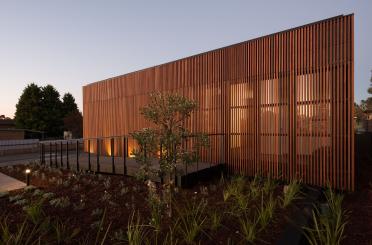 a building with a fence and plants