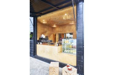 a coffee shop with a counter and a glass display case