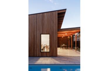 a wooden house with a glass window