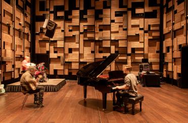 a group of people playing instruments on a stage