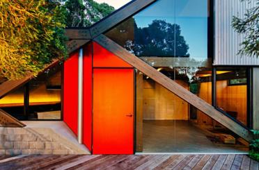 a red door and glass wall of a house