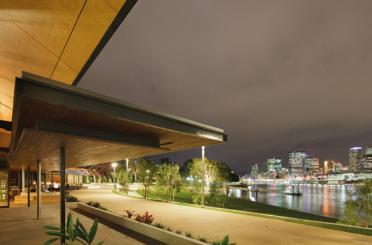 a walkway and walkway with a city in the background