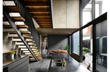 a kitchen with a staircase and a sink