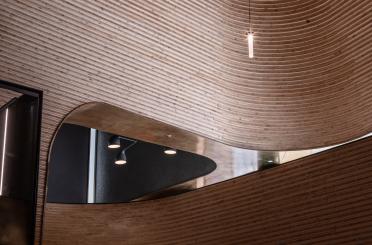 a curved ceiling with lights from the ceiling